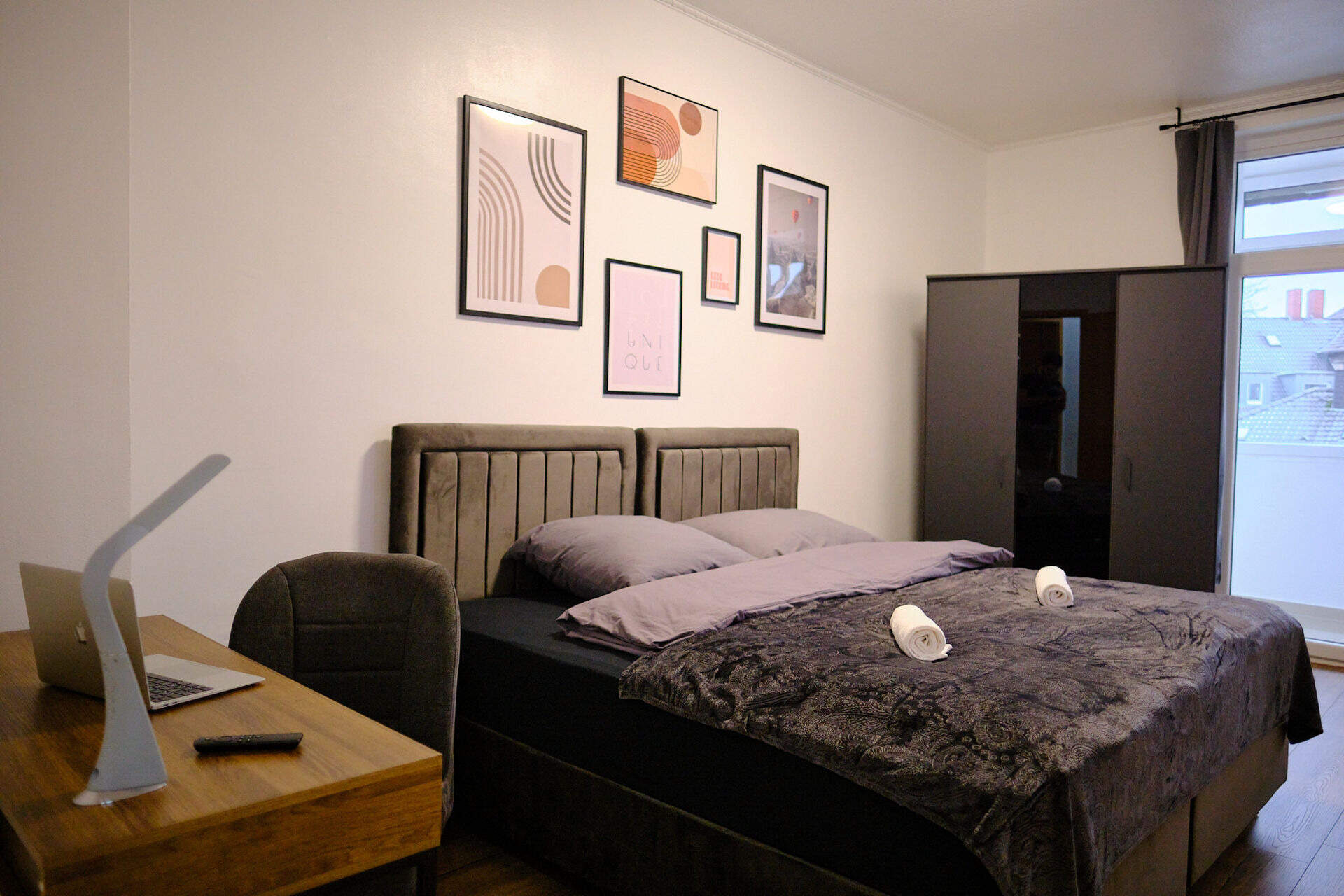 Bedroom with king-size box-spring bed in the period apartment