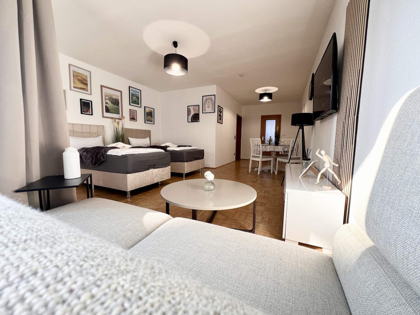 Bright living and sleeping area with box-spring beds, sofa and smart TV near Essen main station